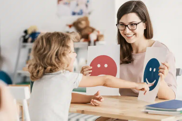 Teacher helps a toddler learn emotions.