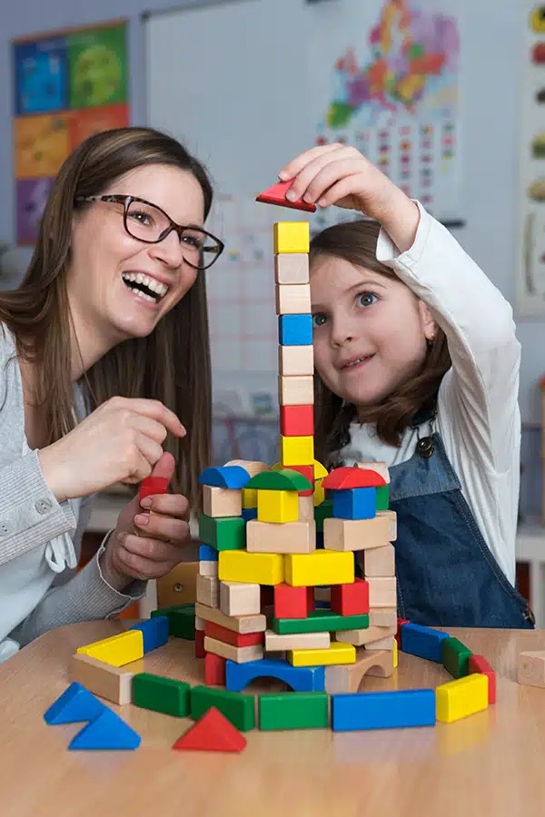 girl plays with blocks as part of emergent curriculum