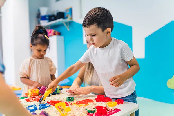 children participating in messy play at daycare