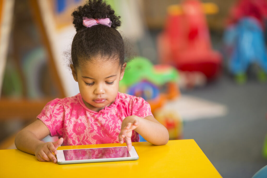 Preschooler uses technology as part of curriculum. 